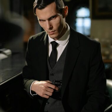 A mysterious man in a suit holding a gun in a noir-style setting, exuding intrigue.