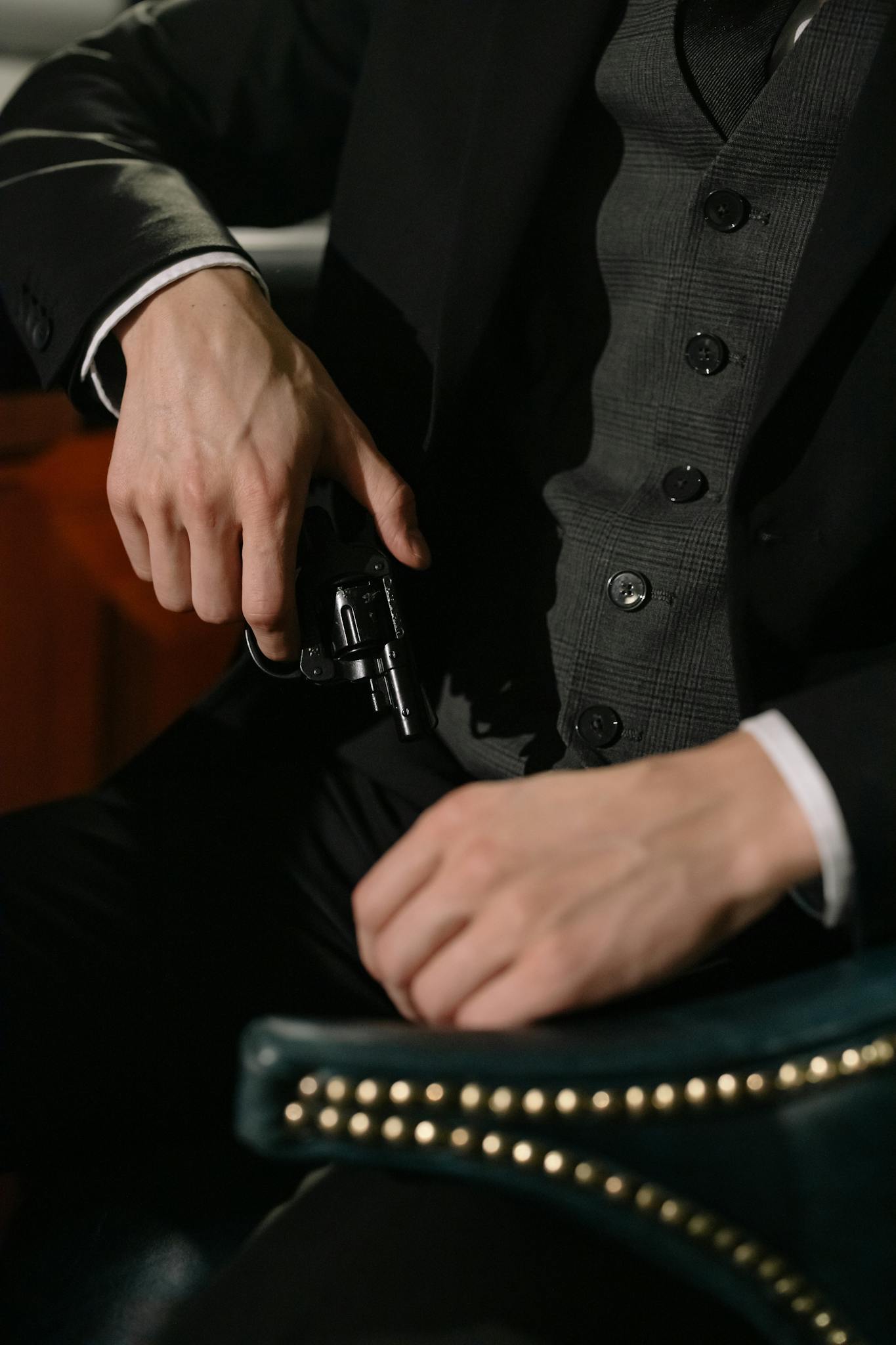 Close-up of a person holding a handgun, exuding a noir and suspenseful vibe.